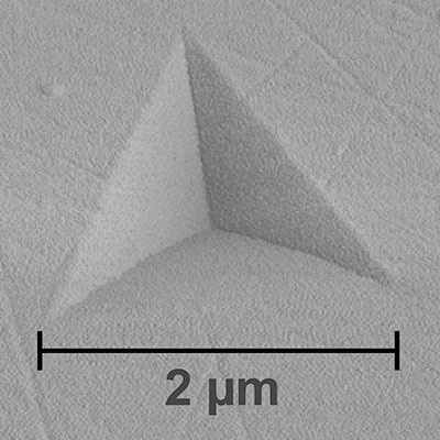 AFM image of a residual imprint produced by a nanoindenter shows the three-sided pyramid